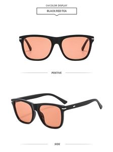 Detailed close-up of square black sunglasses frame with red tea lenses and metal accents