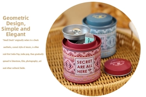 Detail of vintage tin tea canisters with geometric patterns and inner lid handles