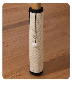 Close-up of sisal cat scratcher mat for table leg protection with a white plush toy ball