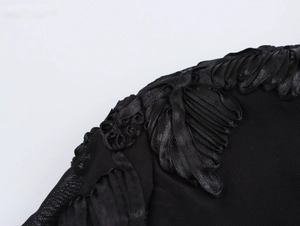 Detailed macro view of black mesh fabric with elegant ribbon embroidery floral patterns