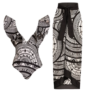 Detail of ruffle sleeve monokini and tie-waist wrap skirt in black and white tribal print