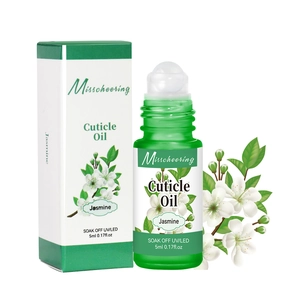 Macro detail of 5ml jasmine cuticle oil roller pen and packaging with white jasmine flowers