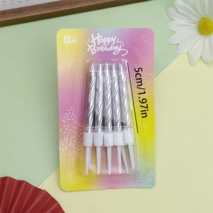 Close-up of 5cm silver spiral birthday candles in rainbow packaging for cake decor