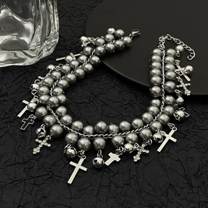 Punk double-layer choker with grey pearls and cross pendants on black textured backdrop
