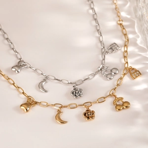 Stainless steel bracelet with moon, cherry and flower charms in gold and silver finish