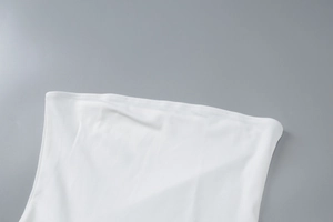 Close-up of the fine stitching and white elastic knitted fabric on the strapless dress