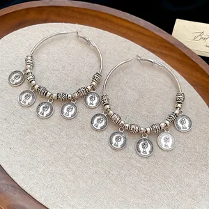 Vintage silver-plated hoop earrings with Elizabeth II coin pendants and tassel details