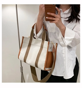 Detailed shot of canvas tote bag with adjustable shoulder strap and contrast stitching