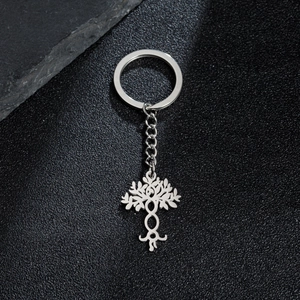 Silver Tree of Life keychain in polished metal on elegant black textured background