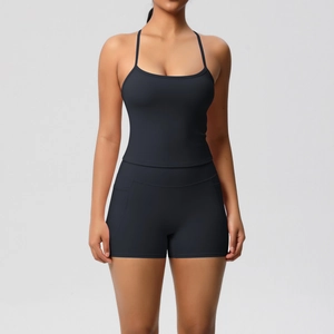 Detail view of seamless black yoga set with spaghetti strap top and high-waist sports shorts