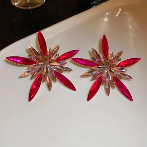 Macro shot of sparkling pink star stud earrings with silver crystals in a tray