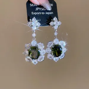Elegant oval emerald green earrings with silver needles and flower zircon accents