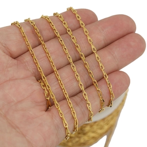 Hand holding golden stainless steel bow chain necklace with oval links for DIY jewelry