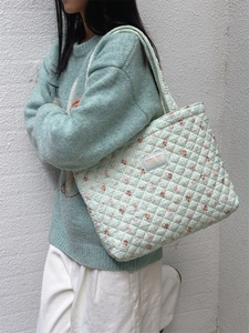 Mint green quilted tote bag with floral rabbit print and Sonikka Studio label detail