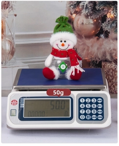 Detail shot of a small snowman Christmas candy jar showing a weight of 50 grams on a scale