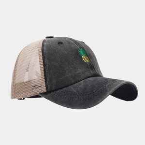 Side view of distressed baseball cap with pineapple embroidery and breathable mesh