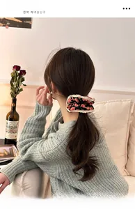 Detail view of floral scrunchie with lace trim worn in hair for a vintage aesthetic
