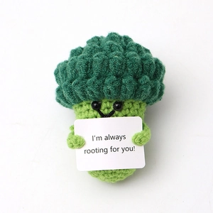 Handmade crochet broccoli doll holding a card saying I'm always rooting for you