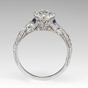 Macro side view of marquise zircon ring with blue sapphire and vintage filigree detail