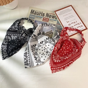 Detailed shot of paisley print hair scarves in black, white and red with elastic bands