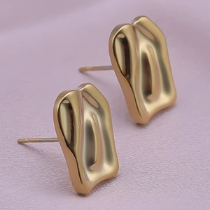 Macro view of gold irregular pleated geometric rectangle stud earrings in 304 stainless steel