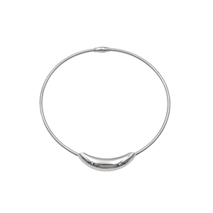 Macro shot of polished silver curved tube pendant on a minimalist snake chain necklace