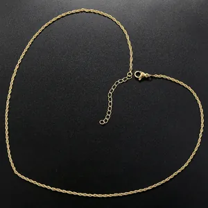Close-up of golden water wave chain necklace with lobster clasp on black background