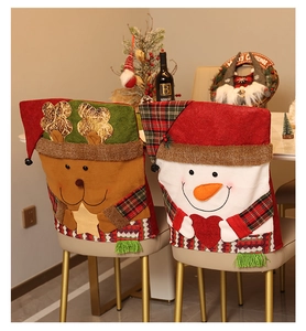 Detailed close-up of festive reindeer and snowman chair covers in a Christmas dining setting