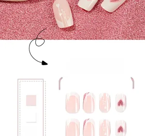 Detail of medium-length French press-on nails with pink glitter hearts and white tips