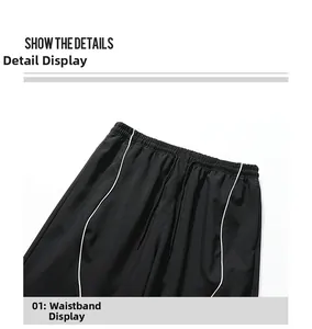 Detail of high waist elastic waistband with adjustable black drawstring and side piping