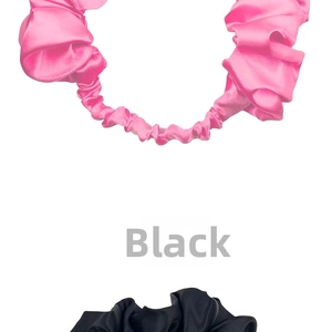 Detailed view of pink and black pleated satin elastic headbands with silky texture