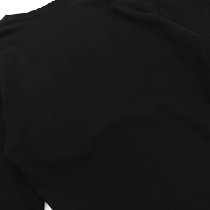 Close-up of black lace deep V-neckline stitching on long-sleeve top with fine knit texture