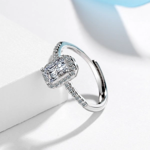 Elegant silver halo ring with rectangular radiant cut cubic zirconia and pavé band accents