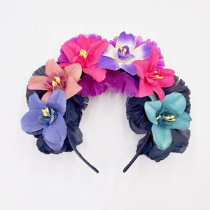 Detailed view of colorful artificial flowers and blue butterflies on a Day of the Dead headband