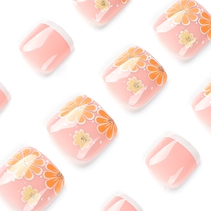 Pink French toenails with white tips and hand-painted yellow flowers on white background