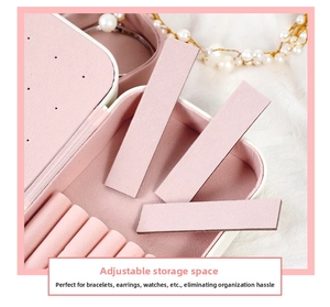 Detail view of the pink PU leather jewelry box featuring adjustable storage compartments