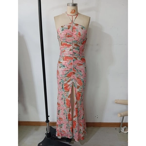 Detail of pink floral halter maxi dress featuring ruching textures and a high front slit