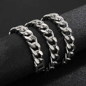 Macro shot of silver Cuban link bracelet with polished finish and secure folding clasp