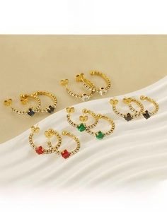 Detail of C-shaped titanium steel earrings with multi-color rhinestones and gold plating