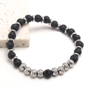 Black volcanic lava stone beaded bracelet with silver textured metal accents on stone