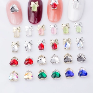 Nail art charms featuring heart crown and teardrop bow designs in assorted colors