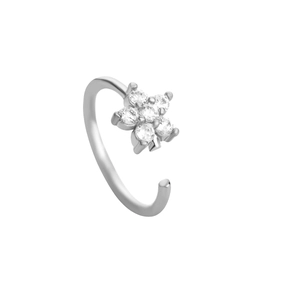 Macro shot of silver C-shaped nose ring featuring a floral rhinestone cluster and polished finish