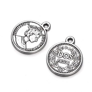 Detailed view showing both sides of antique silver coin pendants for DIY jewelry