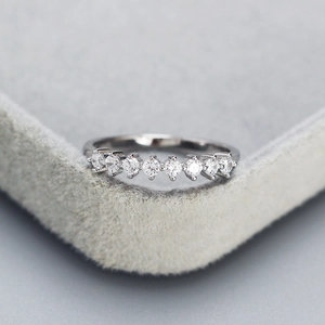 Elegant 925 sterling silver ring featuring a sparkling row of pavé set round diamonds