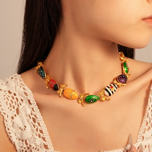 Macro shot of colorful enamel insect necklace with ladybug bee and bow on model