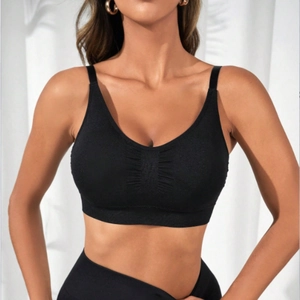 Black seamless sports bra with V-neck and ruched detail for yoga and fitness workout