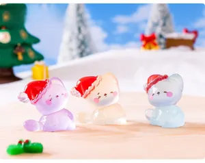 Close-up of three mini translucent Christmas cats in snow scene for micro landscapes
