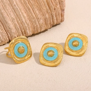 Detail of square 18K gold plated ring and earrings set with turquoise enamel shell motif