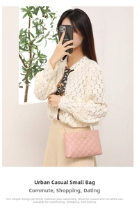 Close-up of a pink quilted mini crossbody bag with a gold chain strap on a model