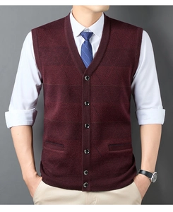 Detail of burgundy knit button cardigan vest paired with white shirt and blue tie